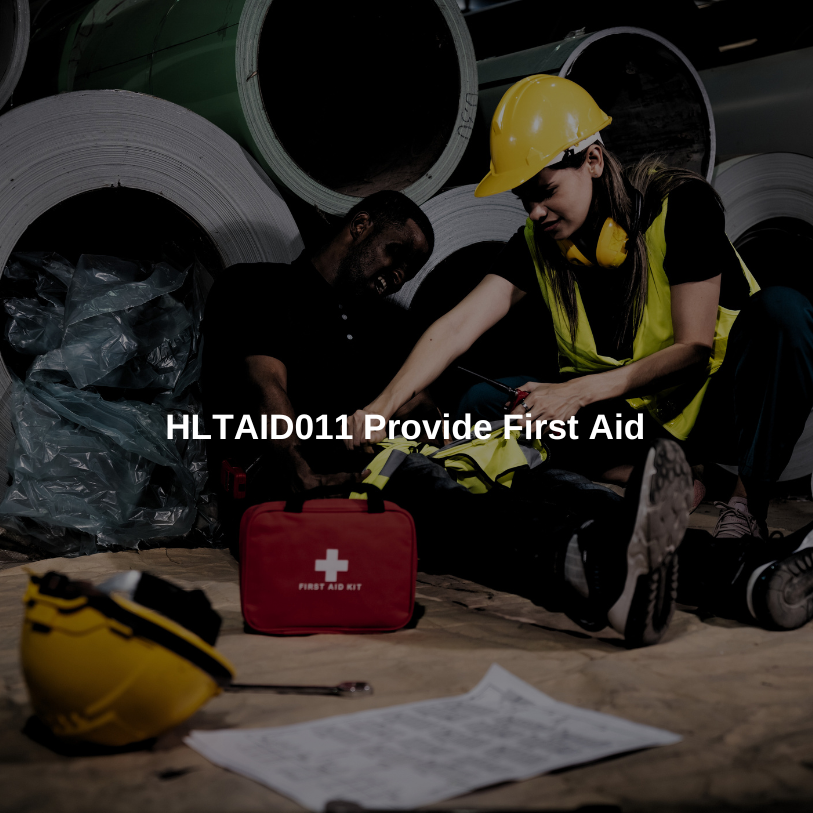 First aid training in a construction setting with workers practicing emergency response.